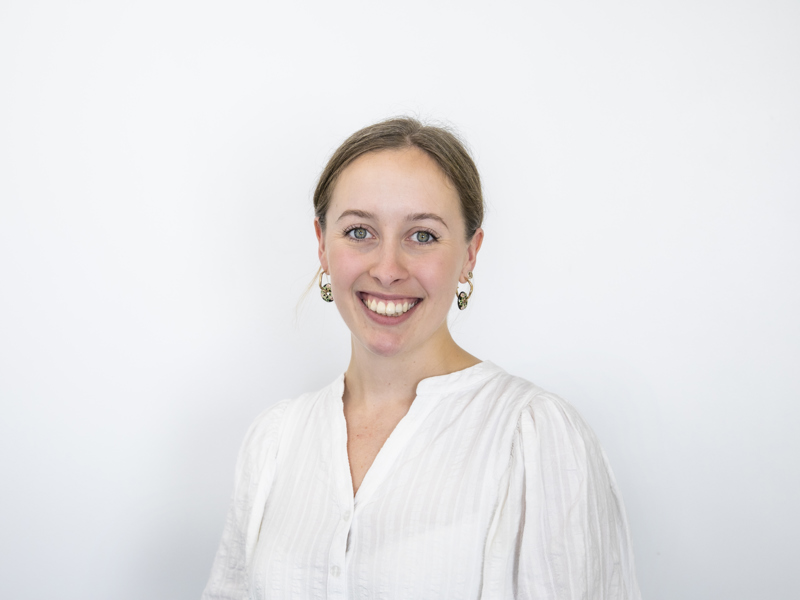 Headshot of Jess Lowe. white female with blonde hair tied back smiling at the camera with a white shirt Headshot of Jess Lowe. white female with blonde hair tied back smiling at the camera with a white shirt